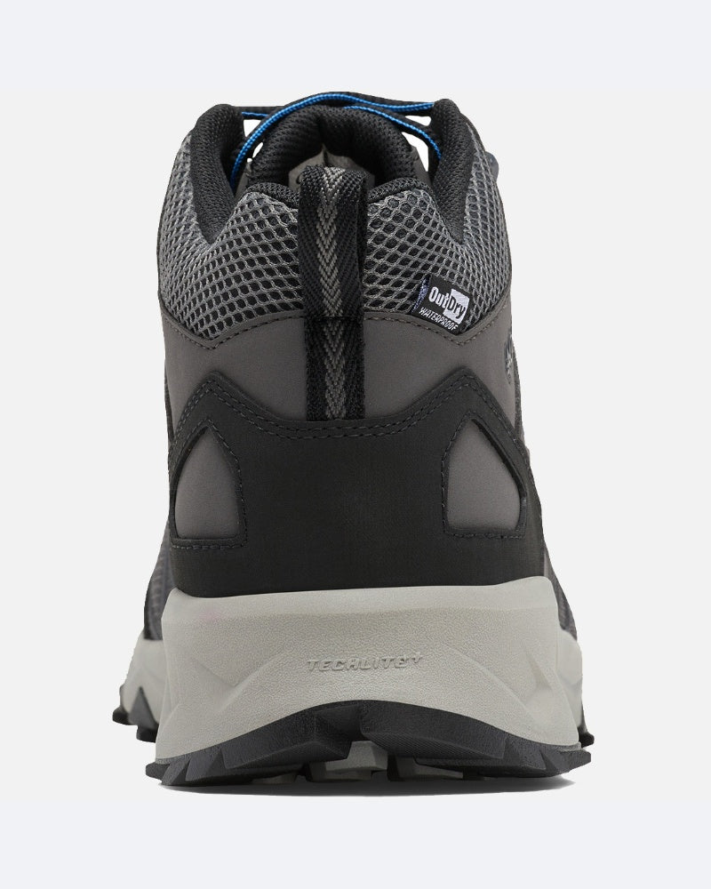 מבט מאחור על נעל טיולים מדגם Columbia IL Peakfreak II Mid Outdry בצבעי אפור ושחור, עם רשת מרקמית, לשונית משיכה, תווית OutDry גלויה וסוליה מגומי הכוללת טכנולוגיית TECHLITE+ בעקב — אידיאלית לשימוש בשטח.