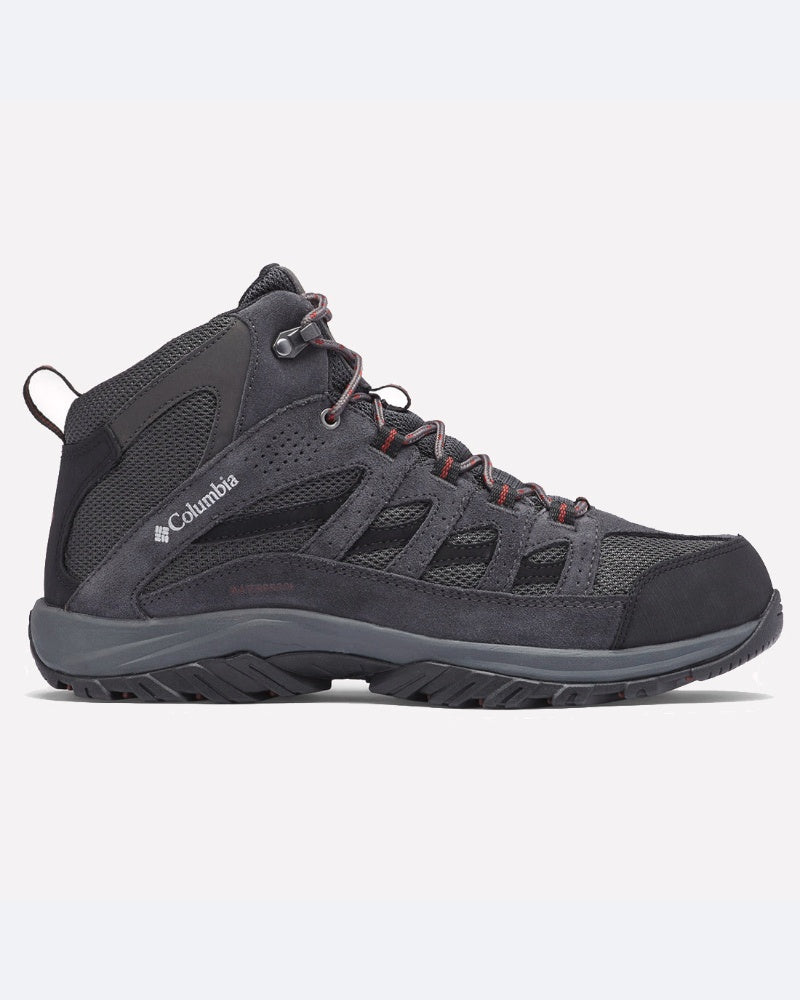 מגף טיולים מסוג ColumbiaIL Crestwood Mid Waterproof בצבעי שחור ואפור כהה, עם לוחות רשת, שרוך אדום וסוליה גומי עמידה, מוצג בפרופיל צדדי על רקע לבן חלק.