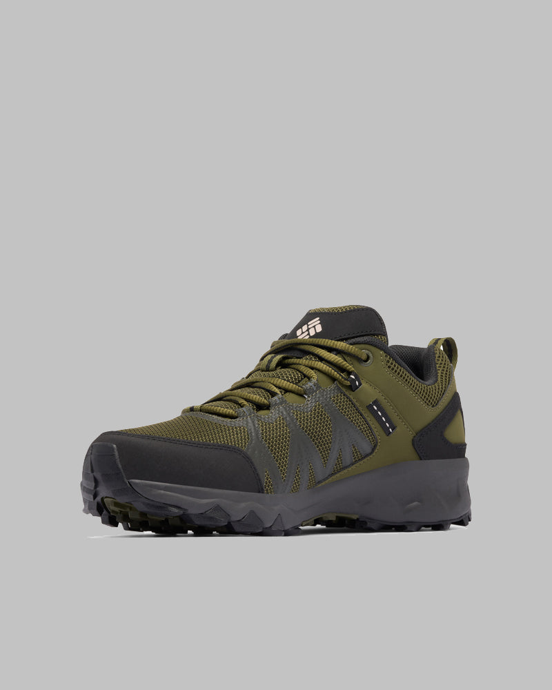 נעל הריצה לשטח ColumbiaIL Peakfreak II Outdry בצבעי ירוק זית ושחור כוללת שכבות רשת וחומר סינתטי, סוליה עמידה וסגירת שרוכים, כפי שמוצג על רקע אפור בהיר.