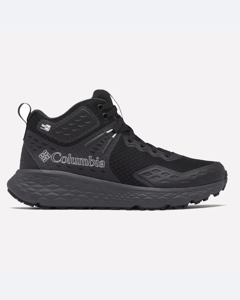 נעל "Konos TRS Outdry Mid" בצבע שחור של המותג ColumbiaIL, עם סוליה מרקמת, חלק עליון מרשת ולוגו בצד, מוצגת בפרופיל שמאלי על רקע ניטרלי — הנעלה אידיאלית לפעילויות בחוץ לכל הרפתקה.