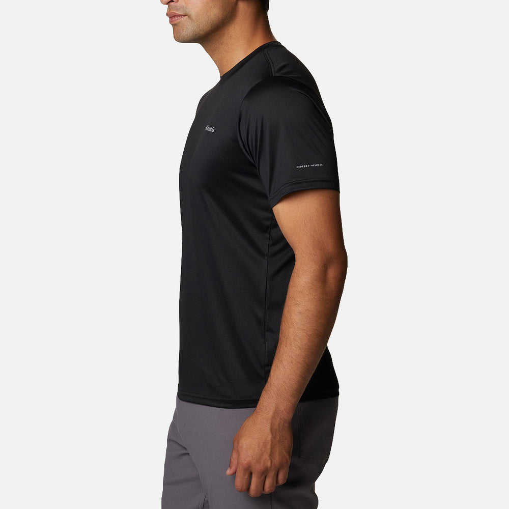 Side view of a man wearing the Columbia Hike Crew Black t-shirt with Omni-Wick on the sleeve, paired with gray pants.