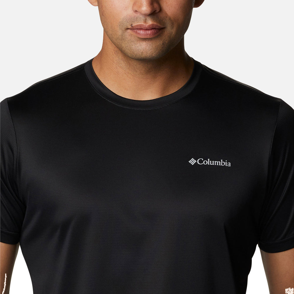 A man wearing the Columbia Hike Crew Black, featuring the logo on the left chest, stands against a plain white background. His face is partially visible from the lips down.