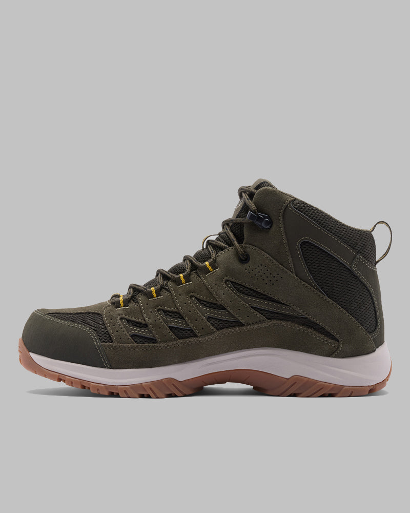 מבט צדדי על מגף קולומביה ישראל Crestwood Mid Waterproof בצבע ירוק זית ושחור, עם לולאות שרוכים צהובות, סוליה אמצעית לבנה וסוליה חיצונית מגומי חום מרקם, המוצג על רקע אפור אחיד.