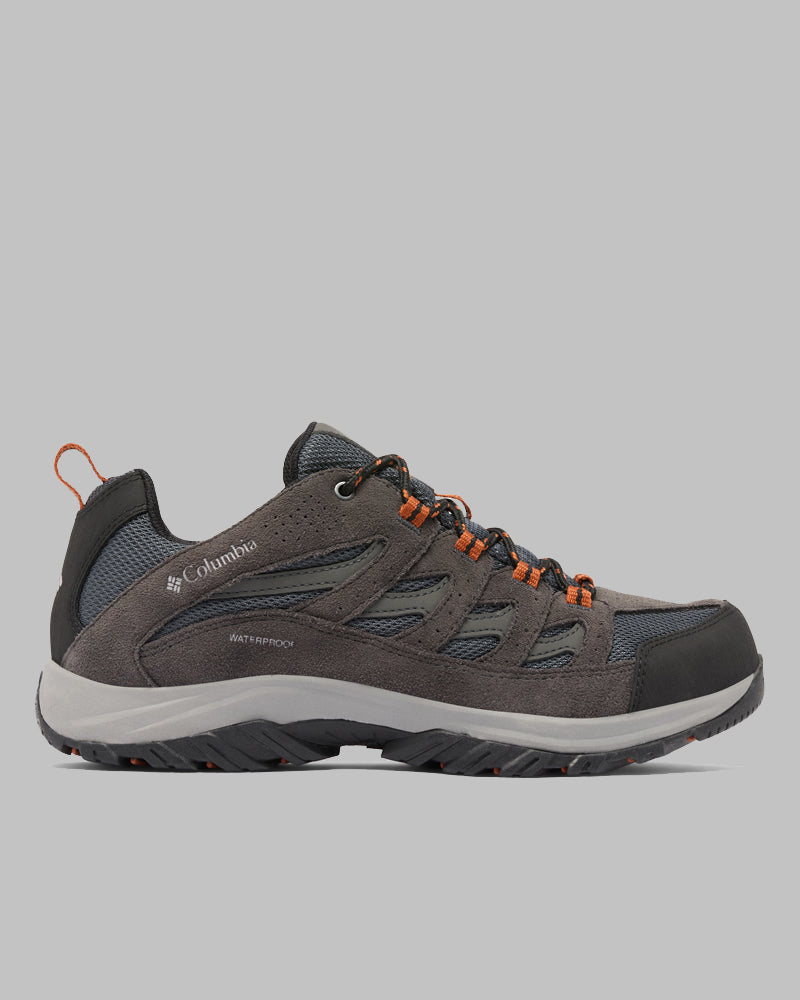 נעלי טיול לגברים מדגם "ColumbiaIL Crestwood Waterproof M" בצבעי אפור ושחור, עם נגיעות כתומות, לוחות רשת וסוליה מרקמית, מוצגות במבט צדדי על רקע אפור אחיד.