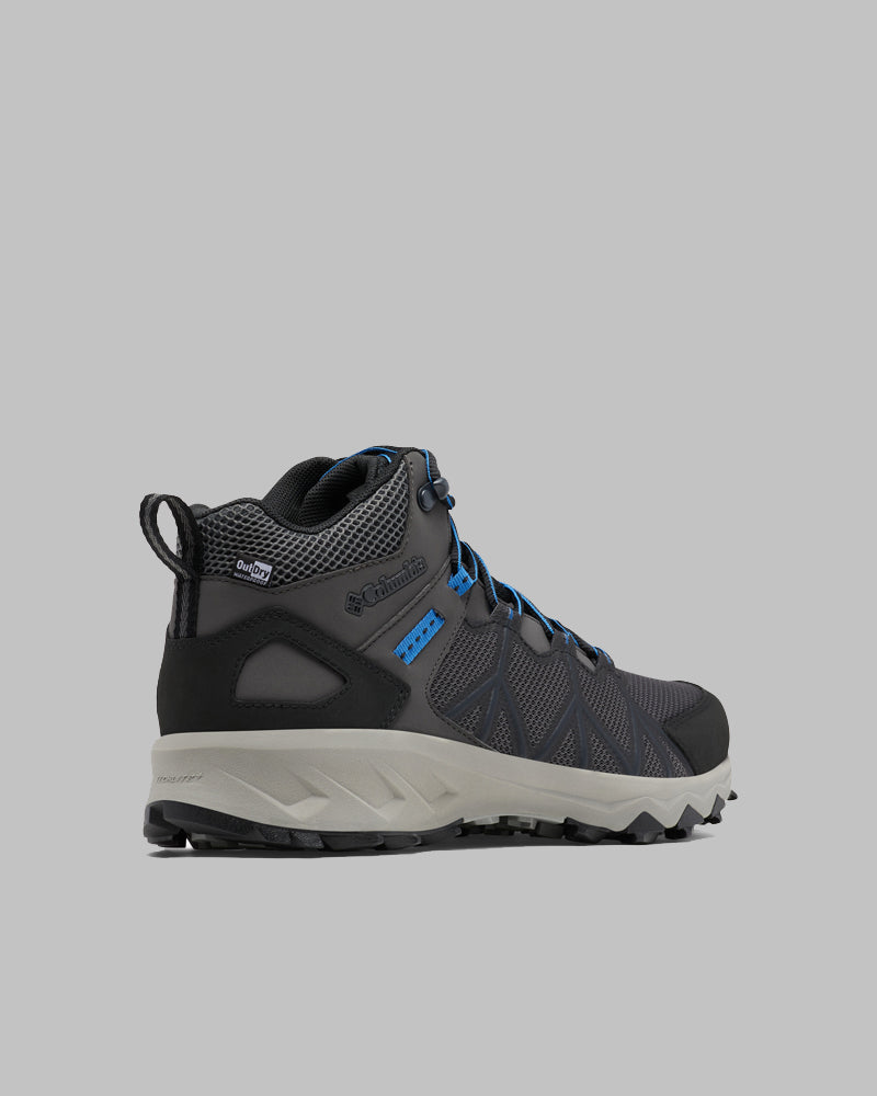 מגף הטיולים לגברים ColumbiaIL Peakfreak II Mid Outdry M בצבעי אפור כהה ושחור עם נגיעות כחולות וסוליה אפורה מוצג בזווית על רקע אפור בהיר אחיד.